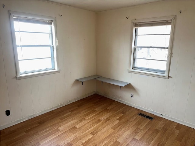 spare room with visible vents and light wood finished floors