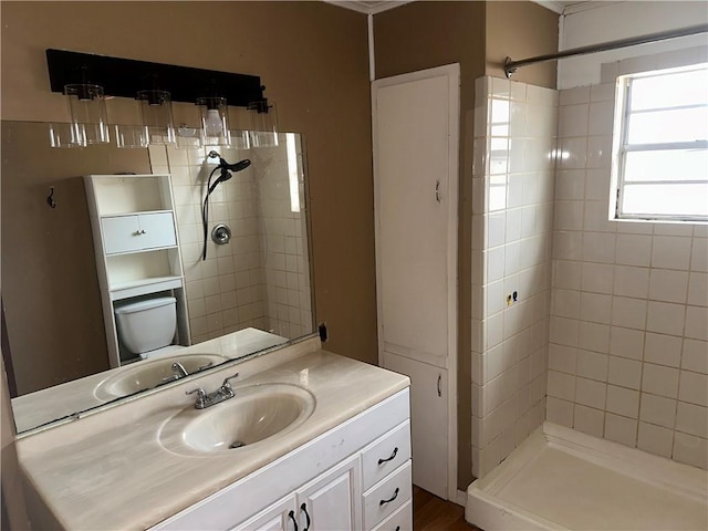 full bathroom featuring toilet, a shower stall, and vanity