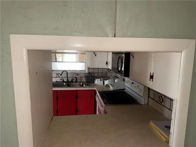 kitchen featuring light countertops, red cabinetry, white cabinets, a sink, and white range oven