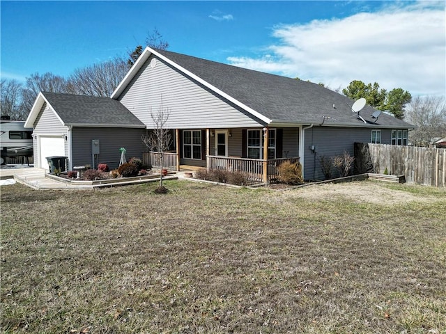 rear view of property with a yard, a shingled roof, covered porch, fence, and a garage