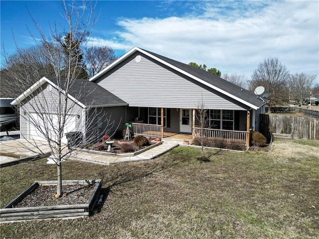 rear view of house featuring a garage and covered porch