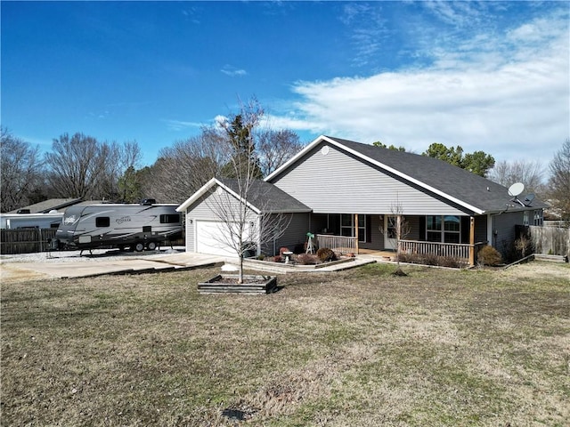 back of house featuring a yard, covered porch, concrete driveway, an attached garage, and fence