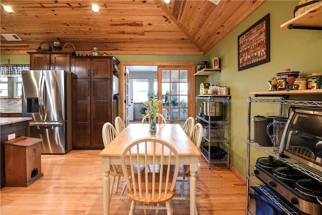 dining space featuring visible vents, wood ceiling, vaulted ceiling, light wood-type flooring, and baseboards