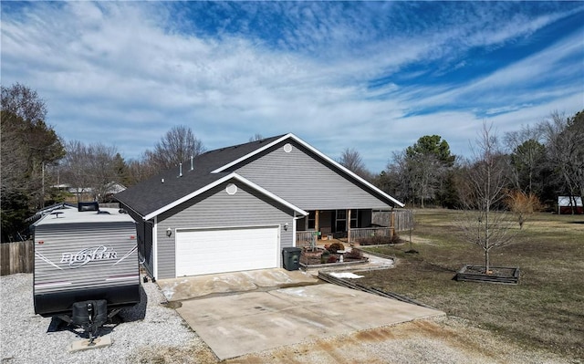 view of side of property featuring a garage, covered porch, a lawn, and concrete driveway