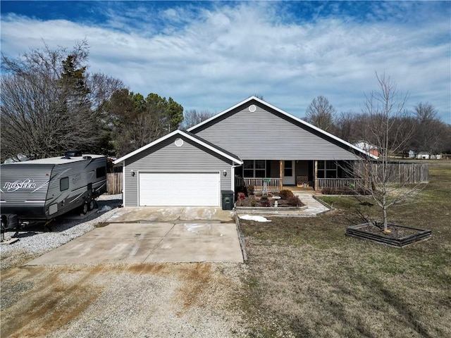 single story home with a garage, covered porch, concrete driveway, and a front yard