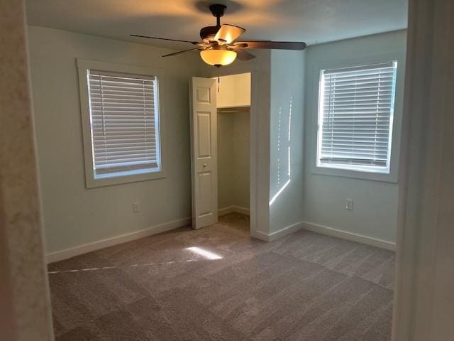 unfurnished bedroom with carpet, a closet, ceiling fan, and baseboards