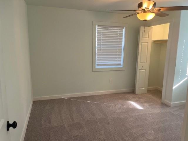 unfurnished bedroom featuring carpet floors, ceiling fan, and baseboards