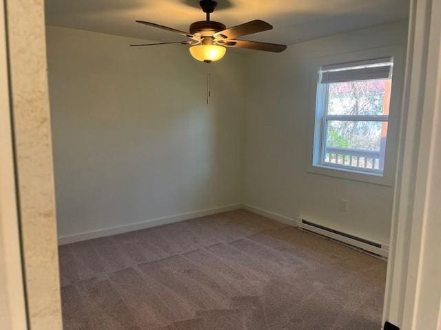 unfurnished room featuring a baseboard heating unit, carpet floors, and baseboards