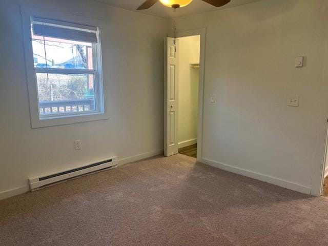 unfurnished room featuring ceiling fan, carpet, baseboards, and baseboard heating