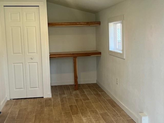 interior space featuring wood finished floors and baseboards