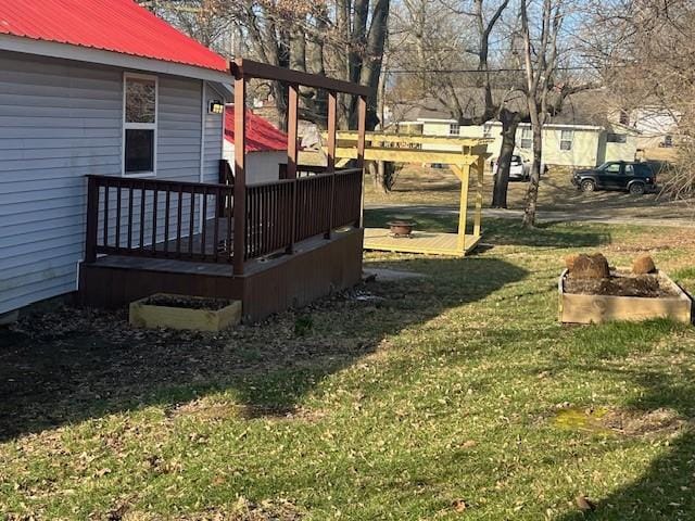 view of yard with a wooden deck and a garden