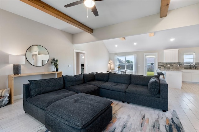 living room with lofted ceiling with beams, a ceiling fan, light wood-style flooring, and recessed lighting