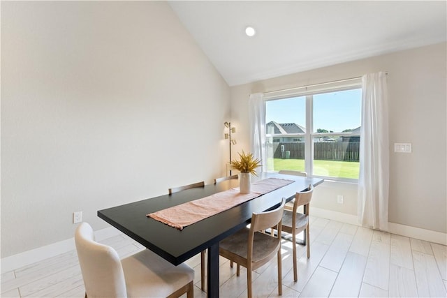 dining area featuring lofted ceiling, light wood-type flooring, baseboards, and recessed lighting