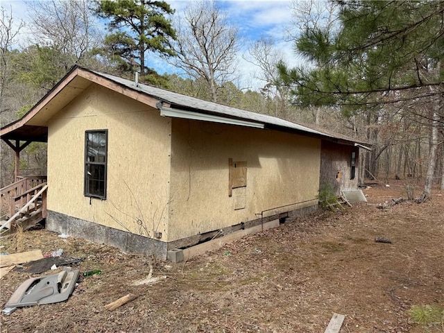 view of side of home with stucco siding