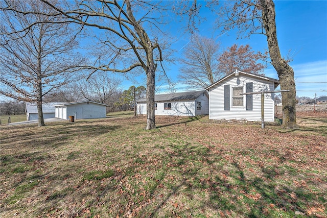 exterior space with an outbuilding and a detached garage