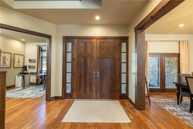 foyer entrance with recessed lighting, baseboards, and wood finished floors