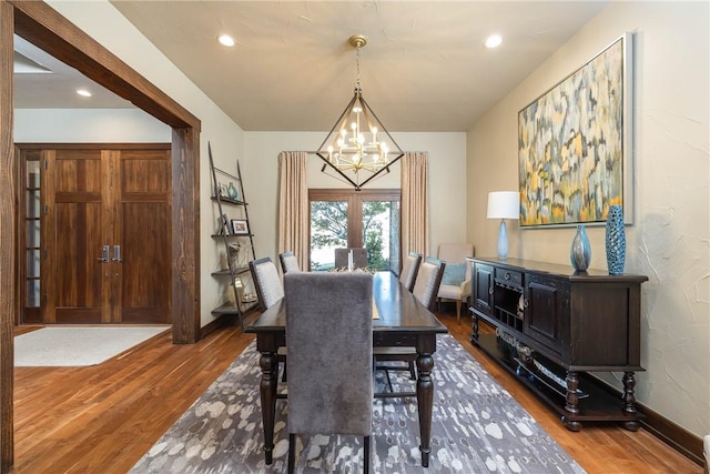 dining room with a notable chandelier, baseboards, dark wood-type flooring, and recessed lighting