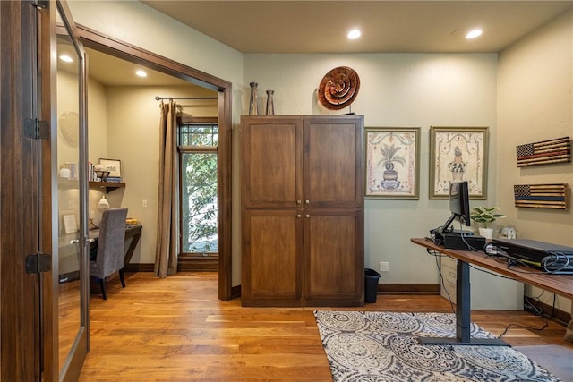home office with recessed lighting, light wood-style flooring, and baseboards