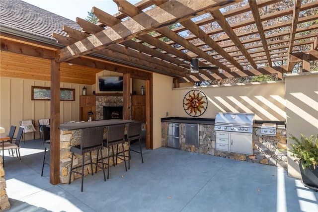 view of patio / terrace featuring exterior kitchen, a pergola, area for grilling, and exterior bar