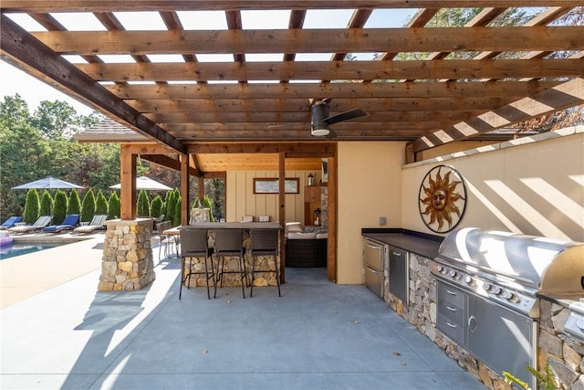 view of patio with outdoor wet bar, a grill, ceiling fan, and area for grilling