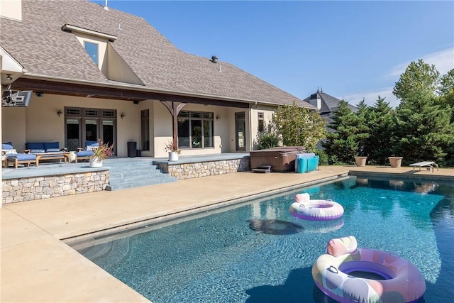 pool with a hot tub, a diving board, french doors, and a patio