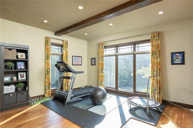 workout area with a healthy amount of sunlight, dark wood finished floors, and recessed lighting