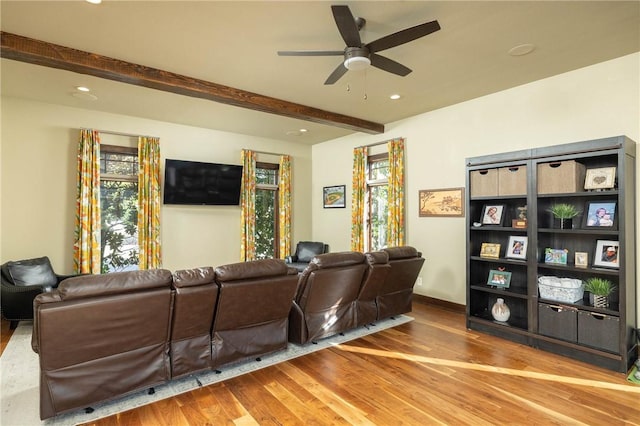 living area with recessed lighting, beamed ceiling, a ceiling fan, and wood finished floors
