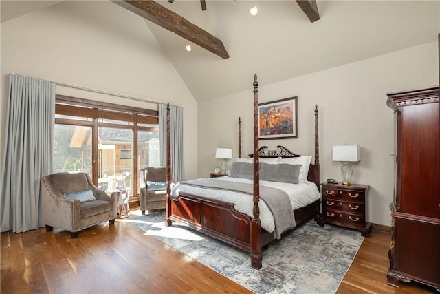 bedroom featuring high vaulted ceiling, beamed ceiling, and wood finished floors