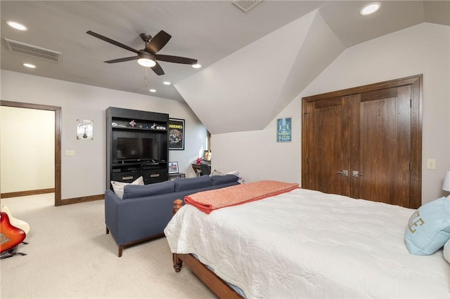 bedroom featuring lofted ceiling, a closet, visible vents, recessed lighting, and light carpet