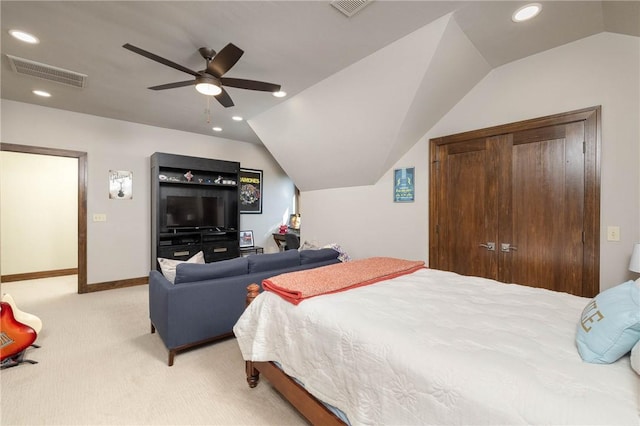 bedroom with visible vents, a closet, recessed lighting, vaulted ceiling, and light colored carpet