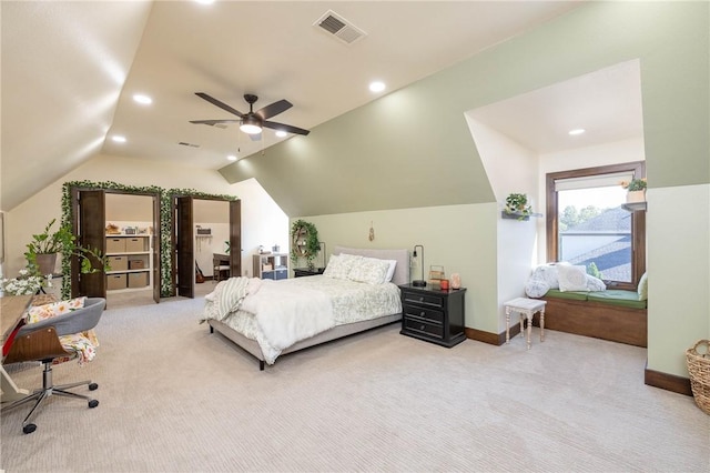 bedroom featuring light colored carpet, visible vents, lofted ceiling, and baseboards