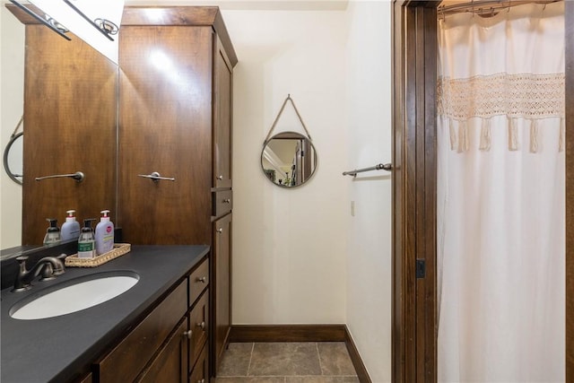 bathroom with a shower with curtain, tile patterned floors, vanity, and baseboards