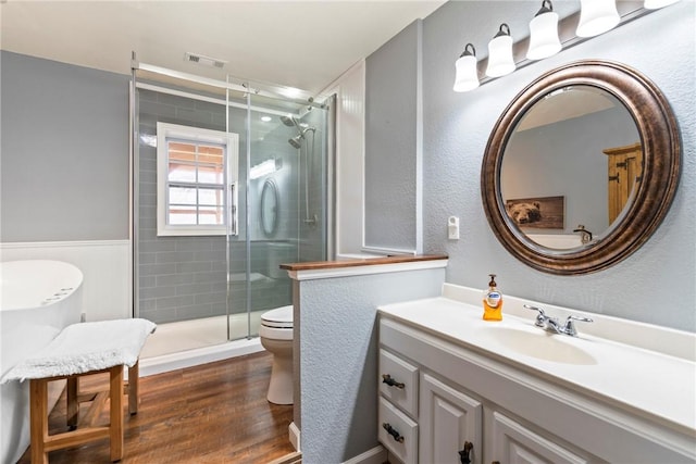19407/19403 Dawn Hill E Rd, Gentry, AR 72734 - bathroom featuring vanity, toilet, wood finished floors, visible vents, and a stall shower
