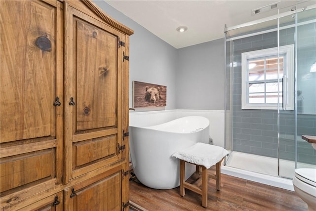 19407/19403 Dawn Hill E Rd, Gentry, AR 72734 - full bathroom featuring visible vents, a freestanding tub, a shower stall, wood finished floors, and toilet