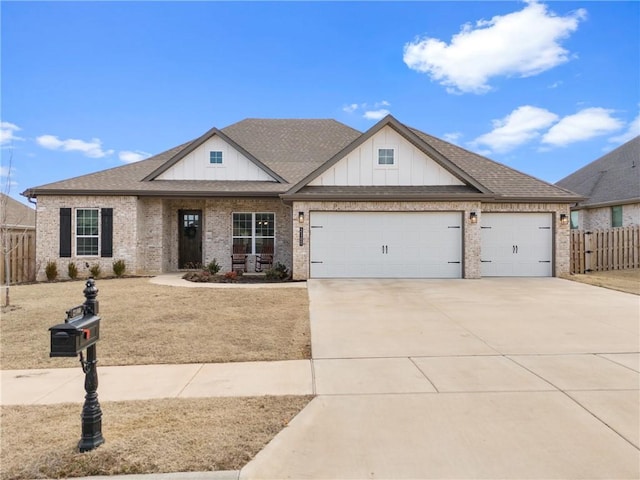 view of front of property with a garage, a shingled roof, concrete driveway, fence, and brick siding