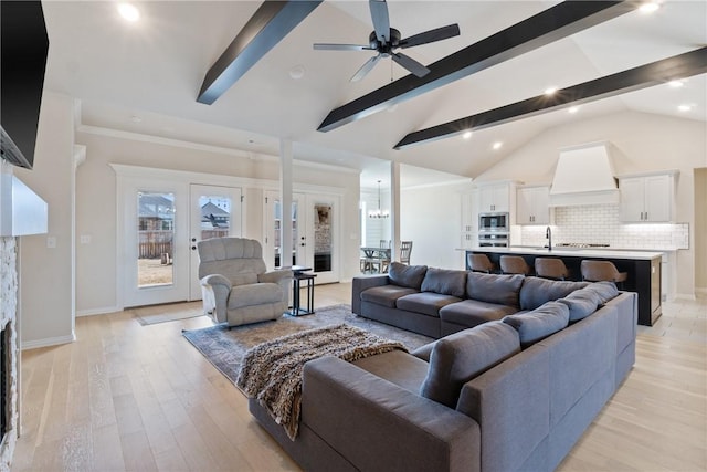 living room featuring high vaulted ceiling, light wood finished floors, baseboards, and beamed ceiling