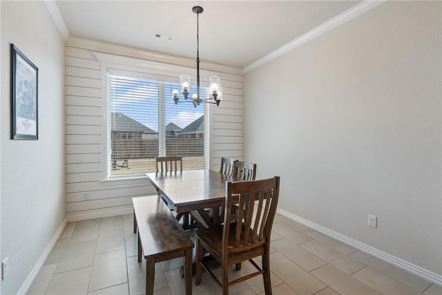 dining area with baseboards, visible vents, a notable chandelier, and ornamental molding