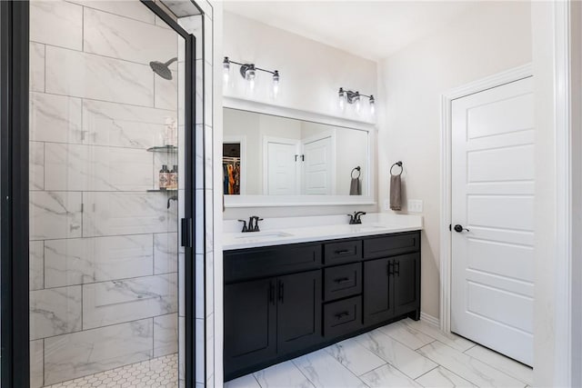 full bath featuring marble finish floor, double vanity, a sink, and a shower stall