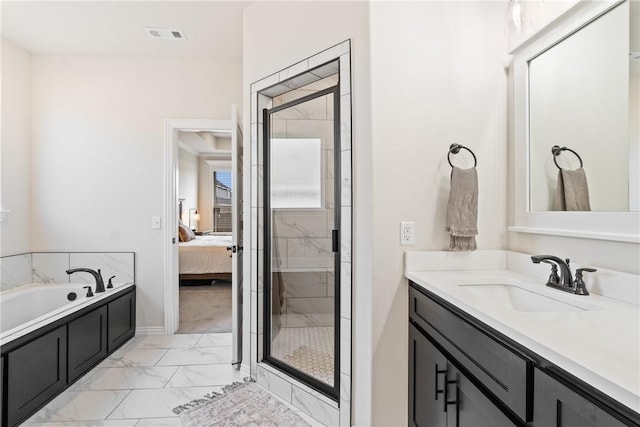 full bathroom with a stall shower, ensuite bath, marble finish floor, a garden tub, and vanity