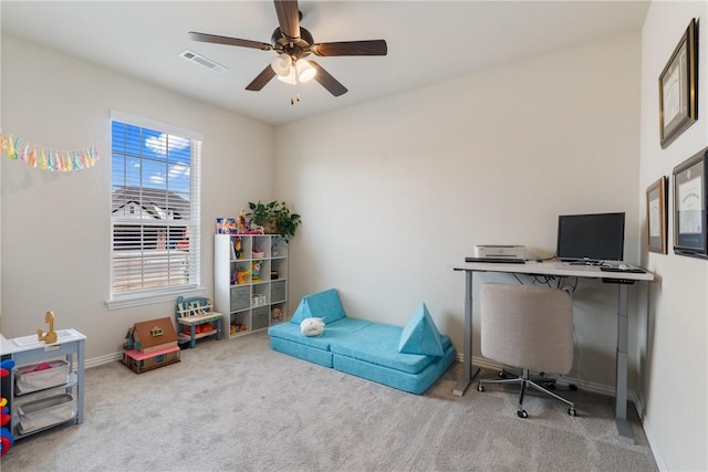 carpeted office space featuring a ceiling fan, visible vents, and baseboards