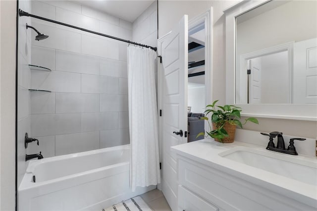 bathroom featuring tile patterned flooring, shower / bath combo with shower curtain, and vanity