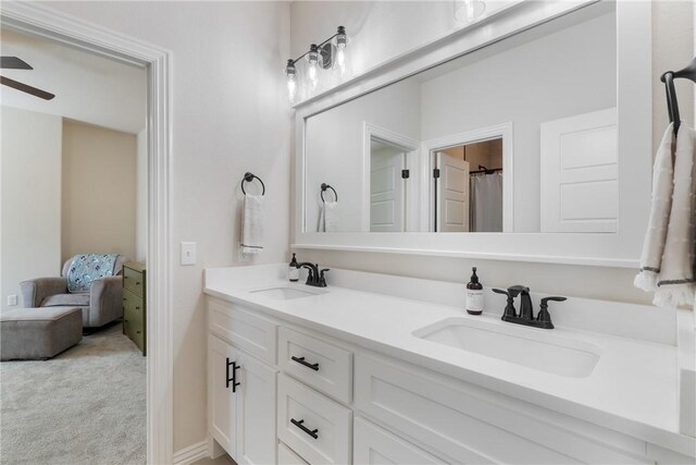 full bath with a ceiling fan, a sink, and double vanity