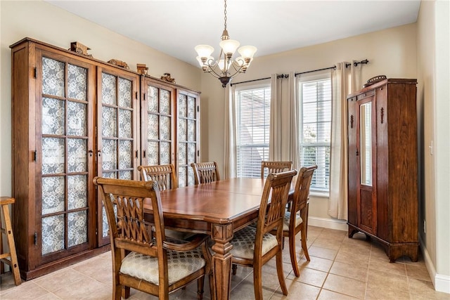 dining room with baseboards, light tile patterned floors, and an inviting chandelier