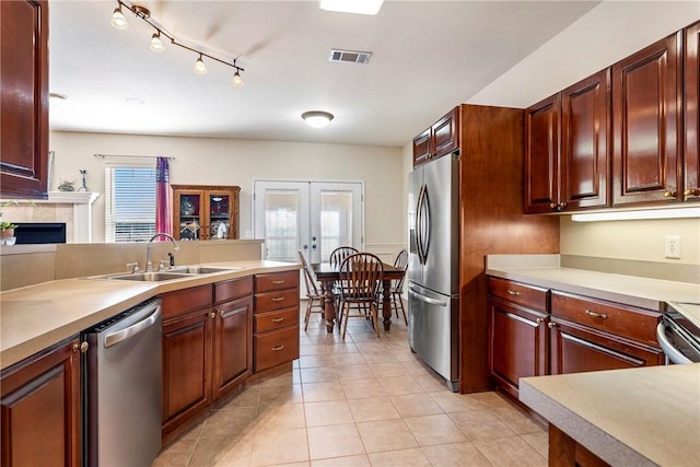 kitchen with french doors, light countertops, visible vents, appliances with stainless steel finishes, and a sink