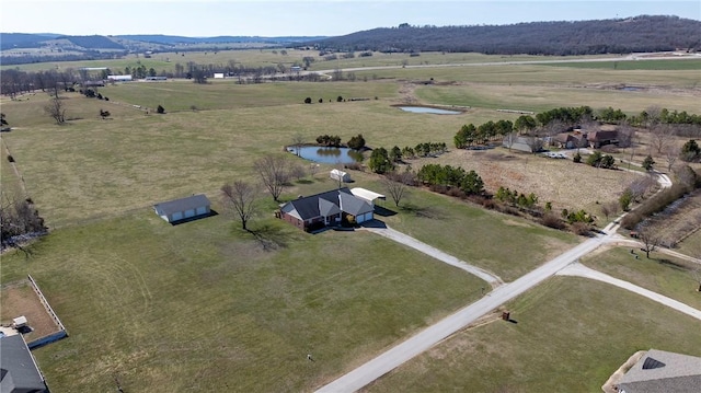 aerial view featuring a water and mountain view and a rural view