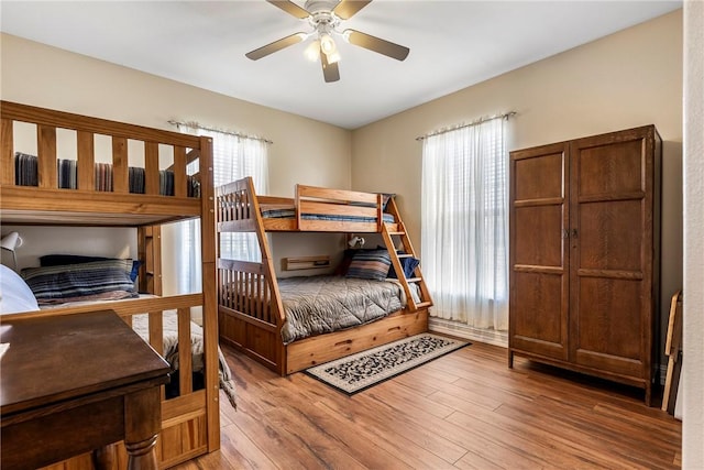 bedroom featuring a ceiling fan and wood finished floors