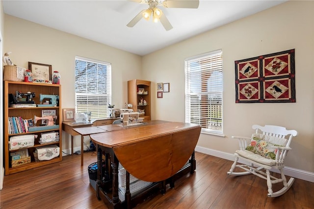 office space featuring ceiling fan, dark wood-type flooring, and baseboards