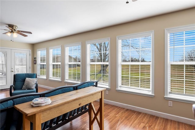 sunroom / solarium featuring a ceiling fan