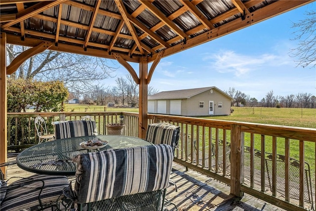 wooden terrace featuring outdoor dining space, a yard, and a gazebo