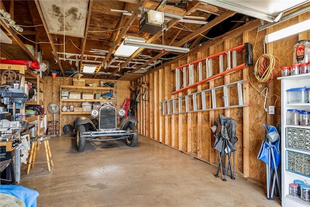 garage featuring a garage door opener and a workshop area